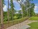 Scenic backyard with a black fence overlooking trees and greenery at 213 Lofty Oak Ln, Holly Springs, NC 27540