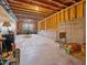 Unfinished basement with exposed ceiling beams and concrete floor, offering ample storage or customization potential at 213 Lofty Oak Ln, Holly Springs, NC 27540