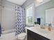 Well-lit bathroom with shower/tub combo and stylish shower curtain at 213 Lofty Oak Ln, Holly Springs, NC 27540