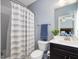 Cozy bathroom featuring a vanity, a toilet, and a shower with a striped curtain at 213 Lofty Oak Ln, Holly Springs, NC 27540