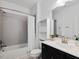 Bright bathroom with white subway tile in the shower and a dark vanity at 213 Lofty Oak Ln, Holly Springs, NC 27540