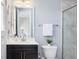 Bathroom featuring a dark wood vanity, shower, and toilet at 213 Lofty Oak Ln, Holly Springs, NC 27540