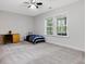Bright bedroom with large windows, carpeted floors, ceiling fan, and minimalist decor at 213 Lofty Oak Ln, Holly Springs, NC 27540