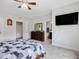 Neutral bedroom with flat screen tv, large bed, and attached bathroom at 213 Lofty Oak Ln, Holly Springs, NC 27540