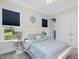 Cozy bedroom with beautiful natural light from large windows and decor throughout at 213 Lofty Oak Ln, Holly Springs, NC 27540