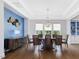 Elegant dining room with stylish decor, hardwood floors, and ample natural light at 213 Lofty Oak Ln, Holly Springs, NC 27540