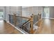 Elegant foyer with hardwood floors, decorative railing, and stylish lighting at 213 Lofty Oak Ln, Holly Springs, NC 27540