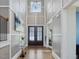 Elegant foyer with soaring ceilings, hardwood floors, and decorative millwork, creating a grand entrance at 213 Lofty Oak Ln, Holly Springs, NC 27540