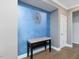 Hallway featuring a blue accent wall and modern decor at 213 Lofty Oak Ln, Holly Springs, NC 27540
