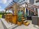 Outdoor hot tub area with a wooden pergola and bar seating, perfect for relaxation and entertainment at 213 Lofty Oak Ln, Holly Springs, NC 27540