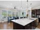 Open kitchen features granite countertops, stainless steel appliances, and a connected breakfast nook with natural light at 213 Lofty Oak Ln, Holly Springs, NC 27540