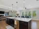 Bright kitchen with a large island, stainless steel appliances, and an open layout at 213 Lofty Oak Ln, Holly Springs, NC 27540
