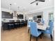 Spacious kitchen and dining area with an open layout, hardwood floors and views of the living room at 213 Lofty Oak Ln, Holly Springs, NC 27540