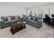 Bright living room features multiple couches and great natural light at 213 Lofty Oak Ln, Holly Springs, NC 27540