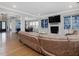 Open-concept living room with hardwood floors, a fireplace, and views into the dining and sun rooms at 213 Lofty Oak Ln, Holly Springs, NC 27540