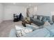 Cozy living room with comfortable couches and a modern entertainment setup at 213 Lofty Oak Ln, Holly Springs, NC 27540