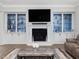 Cozy living room featuring a fireplace, built-in cabinets, and a comfortable seating area at 213 Lofty Oak Ln, Holly Springs, NC 27540
