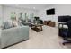 Spacious living room with comfortable seating and a modern entertainment center at 213 Lofty Oak Ln, Holly Springs, NC 27540
