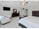 Bedroom featuring high tray ceiling, sitting area with white chairs, and a large closet at 213 Lofty Oak Ln, Holly Springs, NC 27540