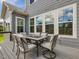 Outdoor seating area on a deck with a table and chairs, perfect for enjoying the outdoors at 213 Lofty Oak Ln, Holly Springs, NC 27540