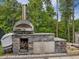 Outdoor stainless steel pizza oven and stone counter, ideal for outdoor cooking at 213 Lofty Oak Ln, Holly Springs, NC 27540
