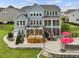 Back of the house with a deck, hot tub, patio, and outdoor seating area at 213 Lofty Oak Ln, Holly Springs, NC 27540