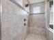 Modern tiled shower featuring a built-in bench and dual shower heads at 213 Lofty Oak Ln, Holly Springs, NC 27540