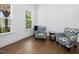 Bright sitting area with hardwood floors and comfortable armchairs, perfect for relaxing and reading at 213 Lofty Oak Ln, Holly Springs, NC 27540