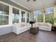 Bright and airy sunroom with large windows and comfortable seating at 213 Lofty Oak Ln, Holly Springs, NC 27540