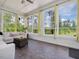 Inviting sunroom with large windows offering views of the surrounding trees at 213 Lofty Oak Ln, Holly Springs, NC 27540