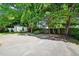 Expansive backyard, featuring a small shed, driveway, and mature trees at 2209 The Circle, Raleigh, NC 27608