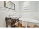 Bathroom with clawfoot tub, modern vanity, and elegant mirror at 2209 The Circle, Raleigh, NC 27608
