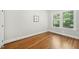 Empty bedroom with gleaming hardwood floors and natural light at 2209 The Circle, Raleigh, NC 27608