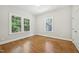 Bright bedroom features hardwood floors, two windows, and white trim at 2209 The Circle, Raleigh, NC 27608