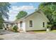 Rear exterior view of a white home with a peaked roof and a small deck at 2209 The Circle, Raleigh, NC 27608
