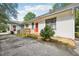 Charming home exterior with a red door, wooden deck, and attractive landscaping at 2209 The Circle, Raleigh, NC 27608