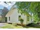Exterior view of the house featuring a backup generator, white siding, and black trim at 2209 The Circle, Raleigh, NC 27608