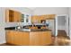 A bright kitchen with wood cabinets, granite countertops, and stainless steel appliances at 2209 The Circle, Raleigh, NC 27608