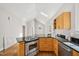 Bright kitchen with black countertops, modern stainless steel appliances, and a center island at 2209 The Circle, Raleigh, NC 27608