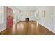 Bright living room featuring hardwood floors, a brick fireplace and a red door to the front yard at 2209 The Circle, Raleigh, NC 27608