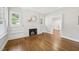 Bright living room with hardwood floors, a painted brick fireplace, and built in shelves at 2209 The Circle, Raleigh, NC 27608