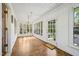 Inviting sunroom with natural light, wood floors, and access to a welcoming welcome mat at 2209 The Circle, Raleigh, NC 27608