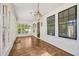 Bright sunroom features hardwood floors, multiple windows, and a stylish hanging lantern at 2209 The Circle, Raleigh, NC 27608