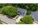 Aerial view of a two-story home with mature trees, a driveway, and a well-manicured lawn at 2309 Filigree Ct, Raleigh, NC 27614