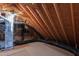 Exposed attic rafters and an air handler highlight the unfinished attic space at 2309 Filigree Ct, Raleigh, NC 27614