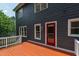 View of the home's back exterior with a wood deck and red back door at 2309 Filigree Ct, Raleigh, NC 27614