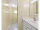 The bathroom has a vanity with a white sink and countertop, with a hallway leading to a window at 2309 Filigree Ct, Raleigh, NC 27614