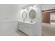 Bathroom with double vanity, large mirrors, tiled floors and view of the bedroom at 2309 Filigree Ct, Raleigh, NC 27614