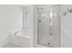 Bathroom featuring a soaking tub and a separate glass enclosed shower at 2309 Filigree Ct, Raleigh, NC 27614