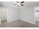 This bedroom features neutral walls, carpeted floors, and a ceiling fan with an attached closet at 2309 Filigree Ct, Raleigh, NC 27614